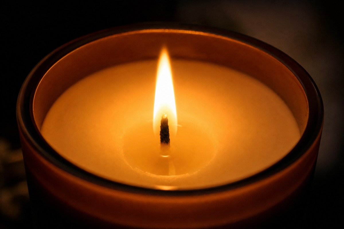 Close-up of the even flame of a natural plant-wax candle