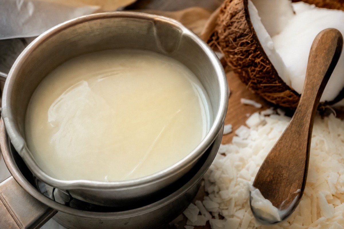 Thick, creamy plant-based wax with coconut and soy flakes ready for pouring